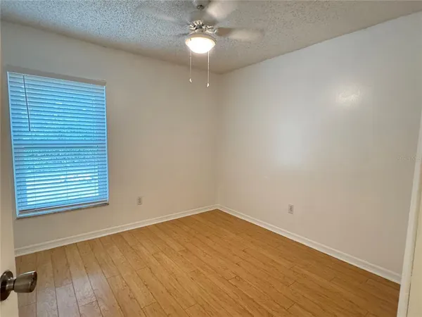 a bathroom with a granite countertop toilet a sink and mirror