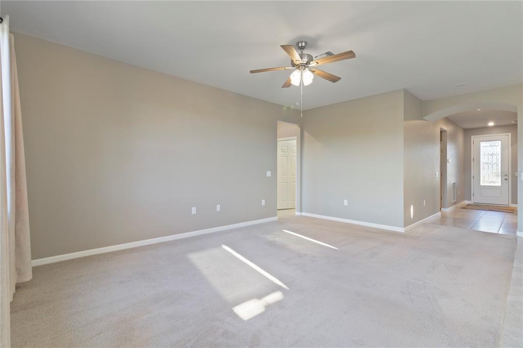 1530 Hyssop Loop North Port, FL 34289 - Photo 15 of 53 a view of an empty room with a chandelier fan
