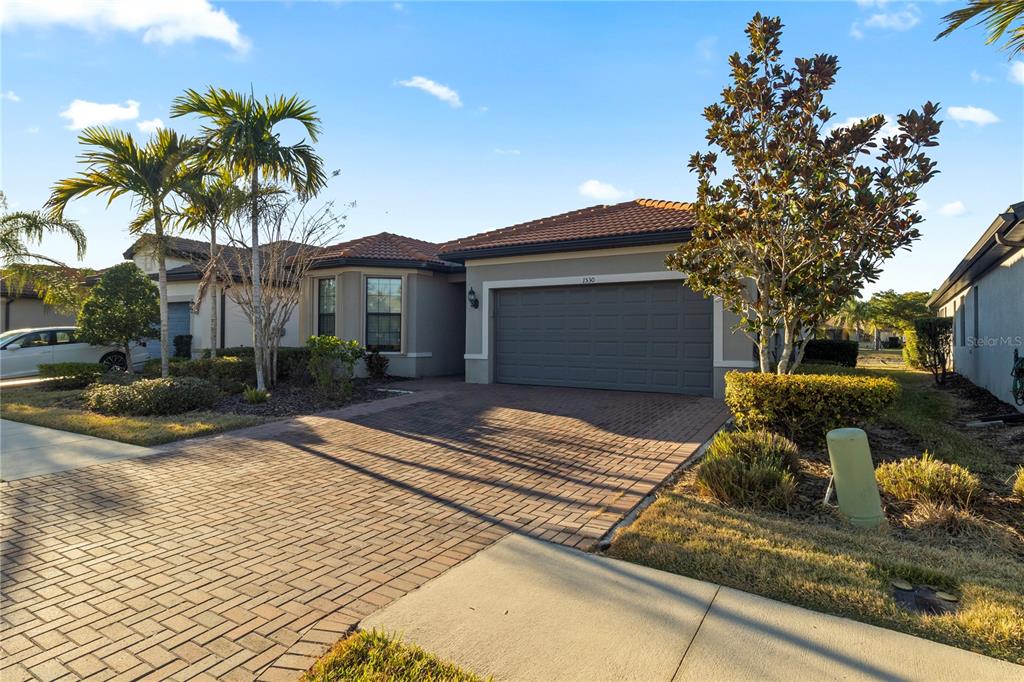 1530 Hyssop Loop North Port, FL 34289 - Photo 3 of 53 a front view of a house with garden