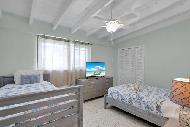 a bedroom with a bed and flat screen tv