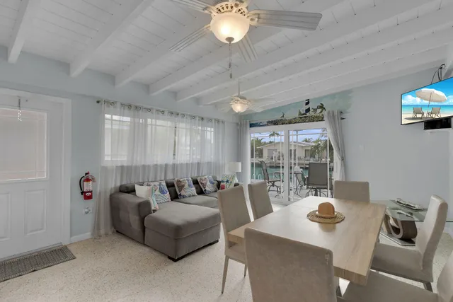 a kitchen with stainless steel appliances a white refrigerator a sink a stove and white cabinets