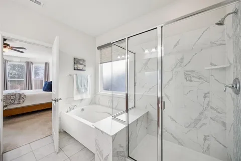 a bathroom with a bathtub and a shower