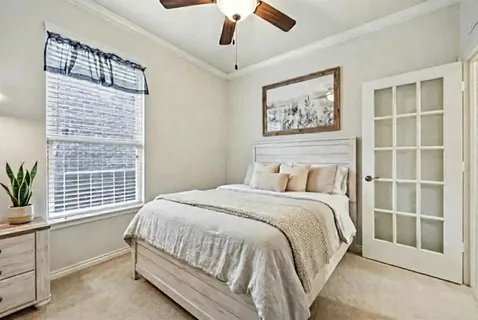 a bedroom with a large bed and a window