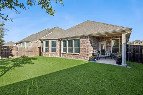 a view of a house with a yard and sitting area