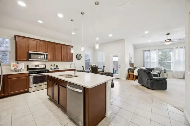 a large kitchen with stainless steel appliances lots of counter space