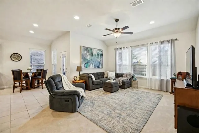 a living room with furniture ceiling fan and a rug