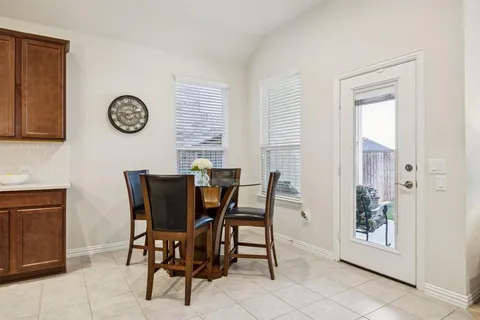 a view of a dining room with furniture and a window