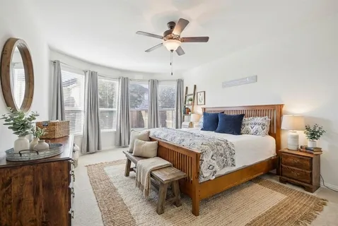 a bedroom with a large bed and a chandelier