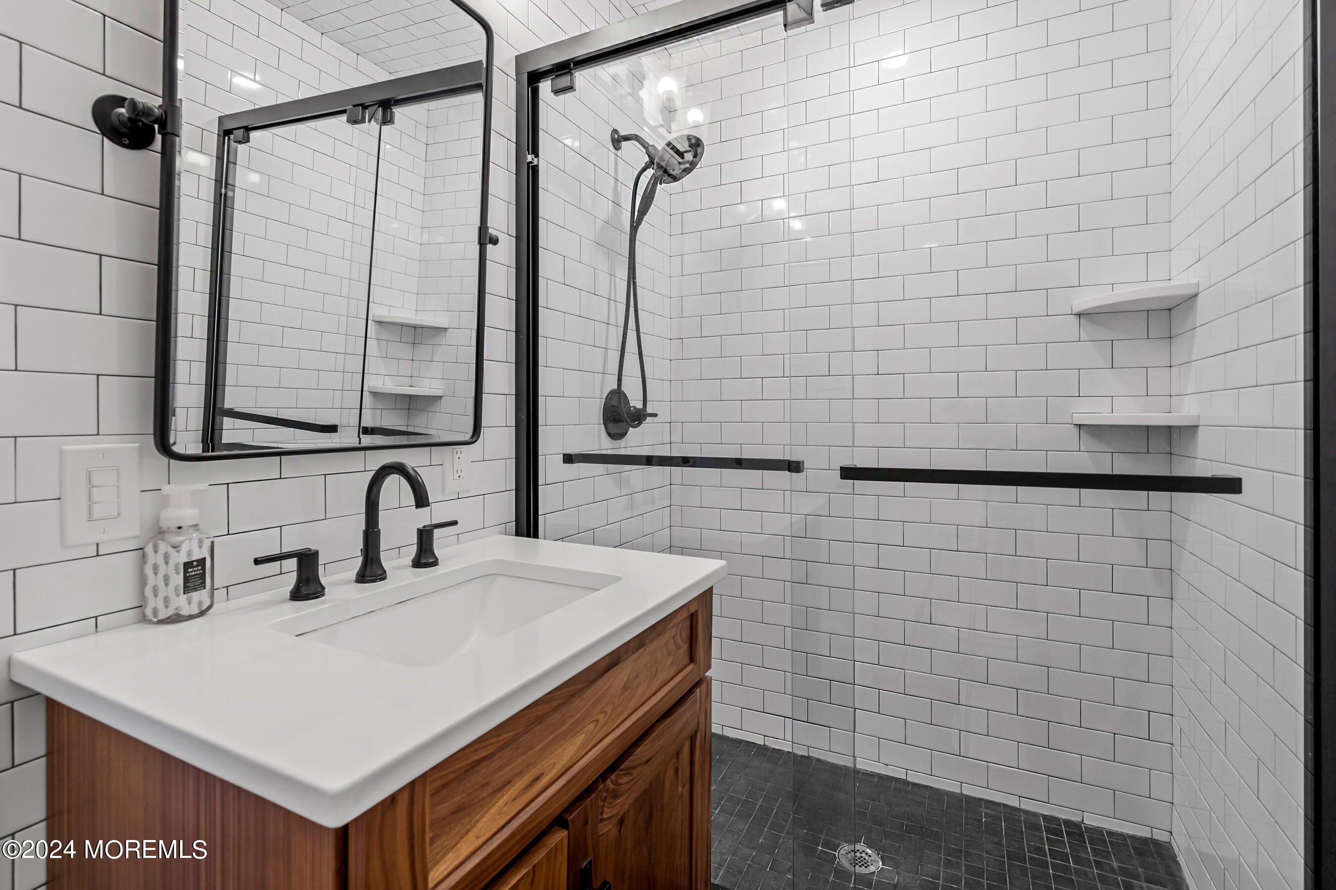 100 Forman Avenue Point Pleasant Beach, NJ 08742 - Photo 18 of 46 a bathroom with a sink vanity mirror and shower