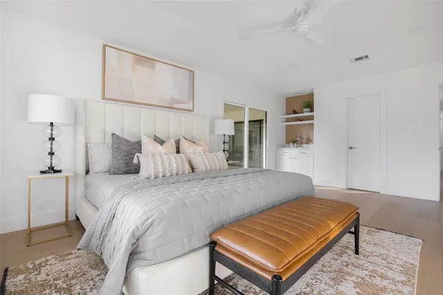 a bed room with a bed and a night stand