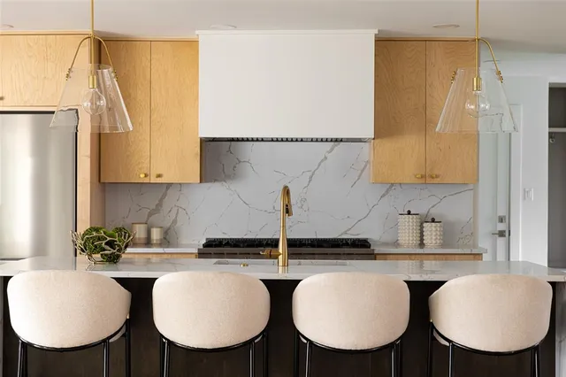 a kitchen with a table chairs sink and cabinets