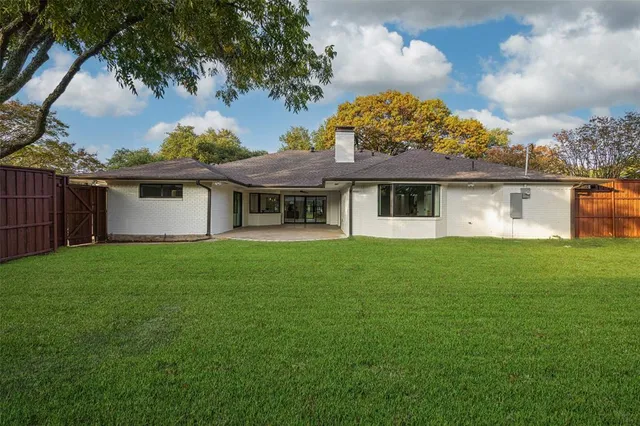 a view of a house with a back yard