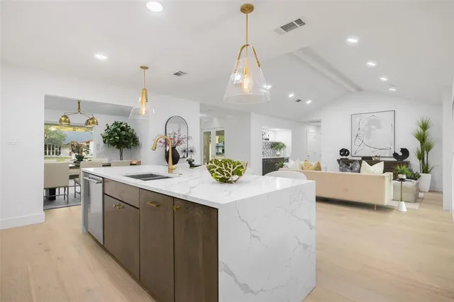 a kitchen with counter top space and living room