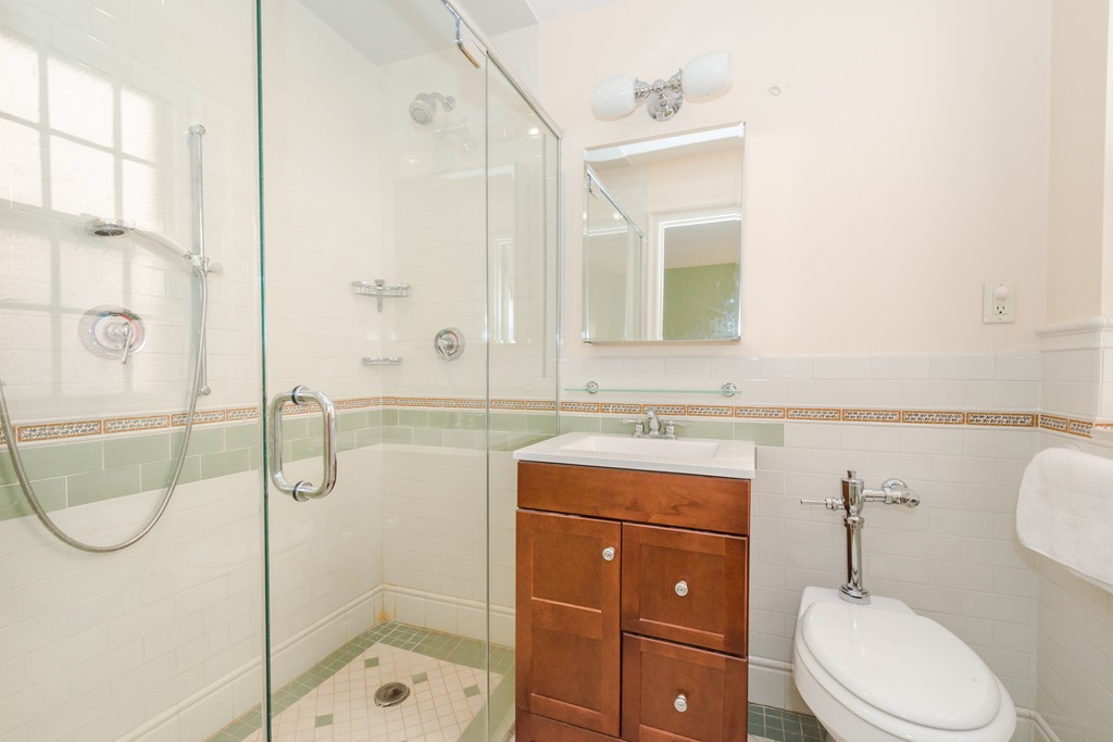 280 Beacon Street, Unit 65 Boston, MA 02116 - Photo 12 of 15 a bathroom with a toilet sink shower and mirror