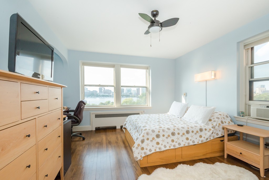 280 Beacon Street, Unit 65 Boston, MA 02116 - Photo 9 of 15 a bedroom with a bed and a chandelier