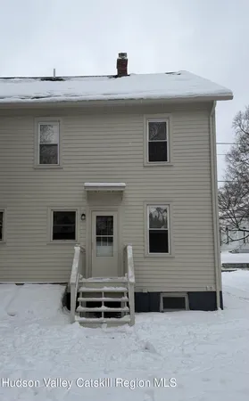 a front view of a house with parking space