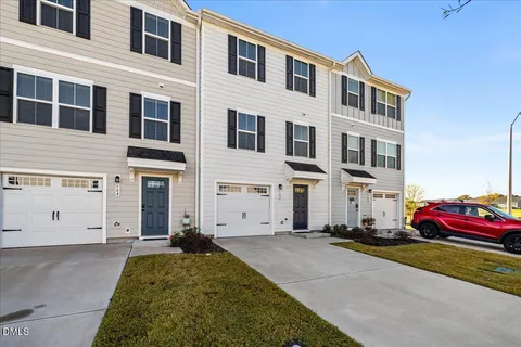 a front view of a building with a garden
