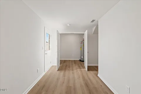 a view of hallway with wooden floor