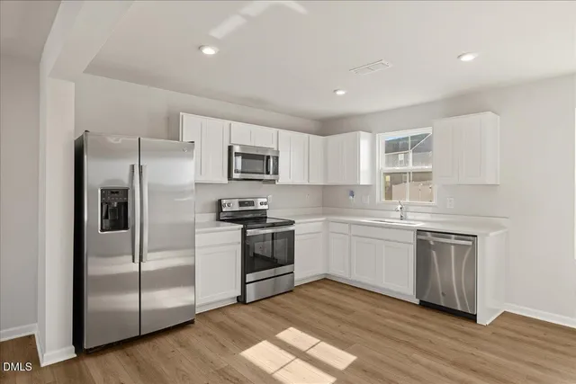 a kitchen with a refrigerator stove and microwave