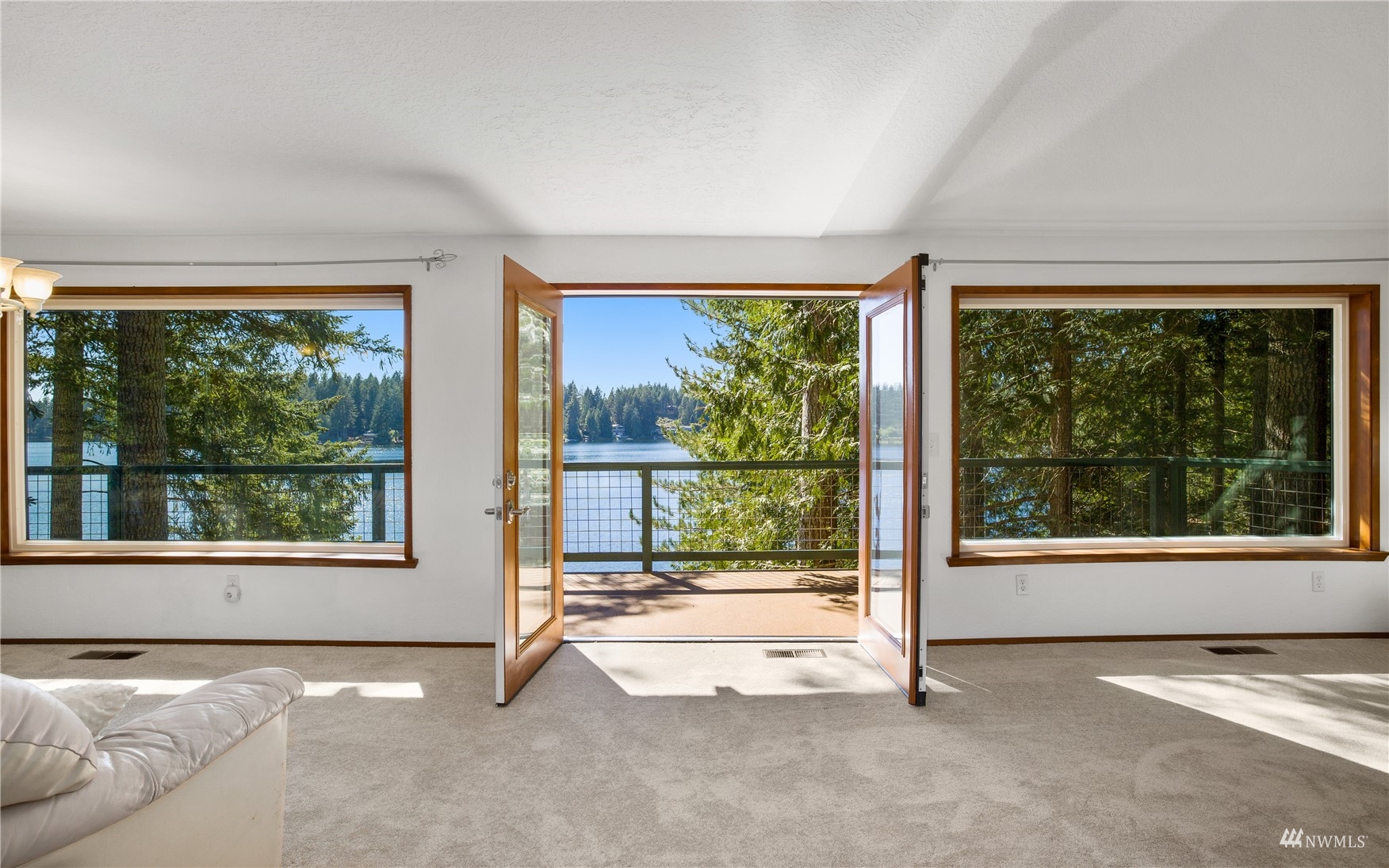 2141 Mason Benson Road East Grapeview, WA 98546 - Photo 13 of 40 a view of an empty room with a fireplace and a large window