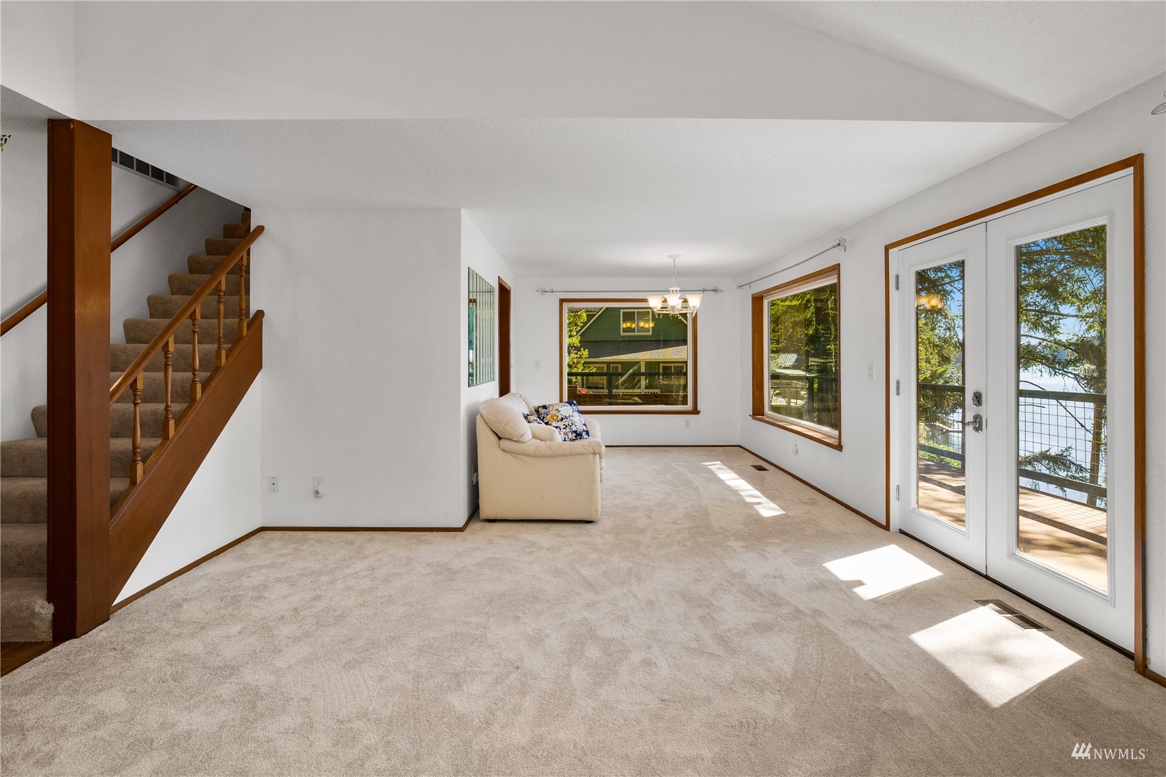 2141 Mason Benson Road East Grapeview, WA 98546 - Photo 15 of 40 a view of a big room with windows and stairs