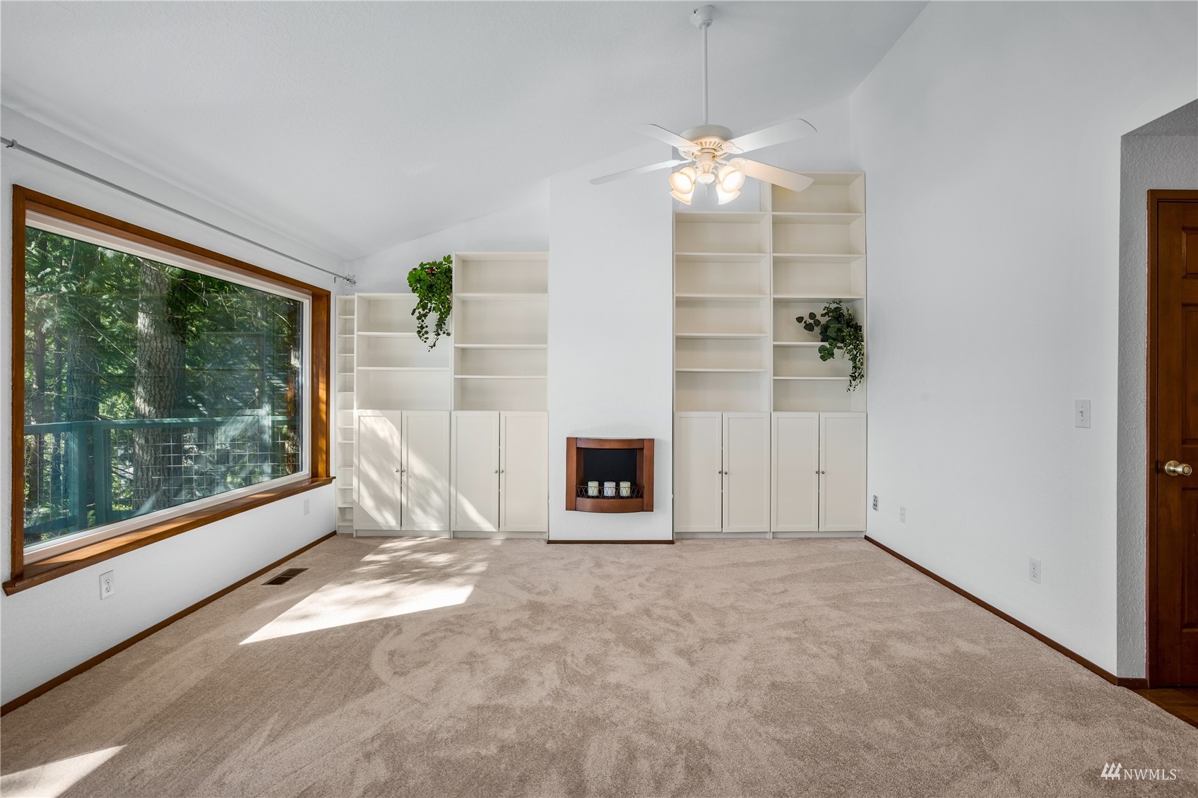 2141 Mason Benson Road East Grapeview, WA 98546 - Photo 17 of 40 a view of an empty room with a fireplace and a window