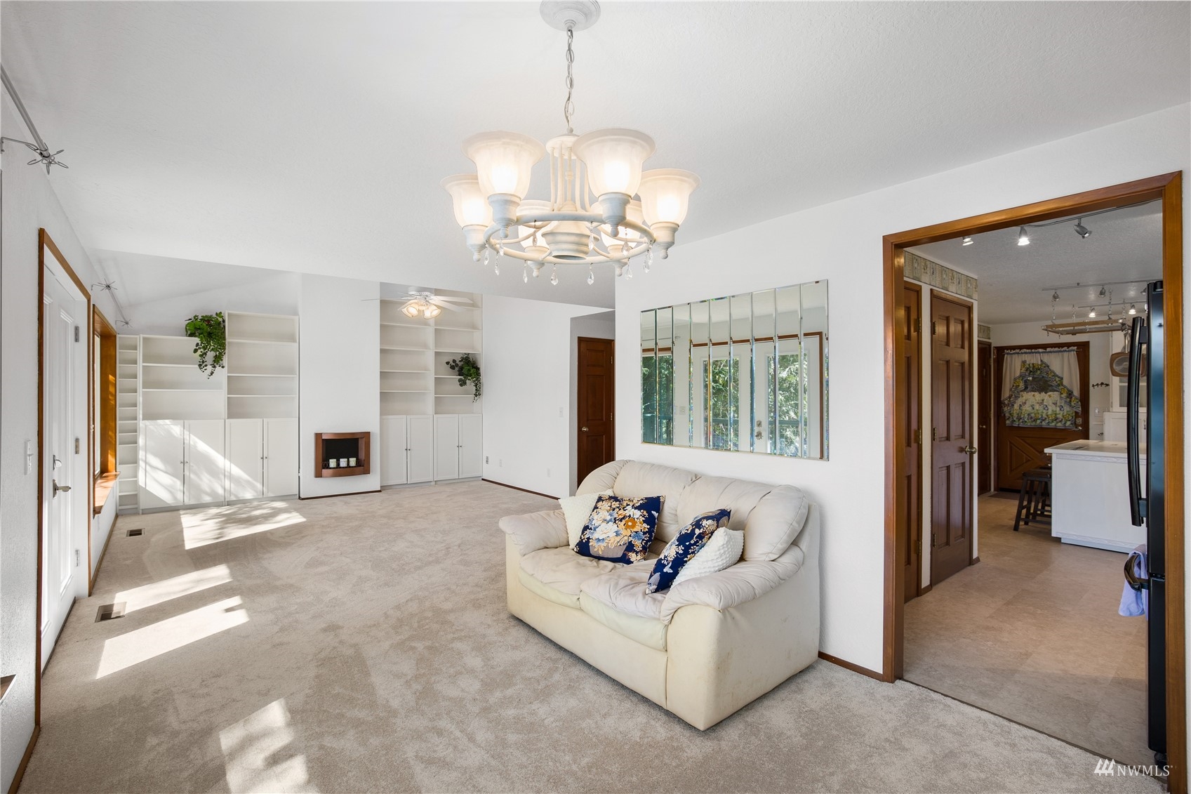 2141 Mason Benson Road East Grapeview, WA 98546 - Photo 19 of 40 a living room with furniture chandelier and a fireplace