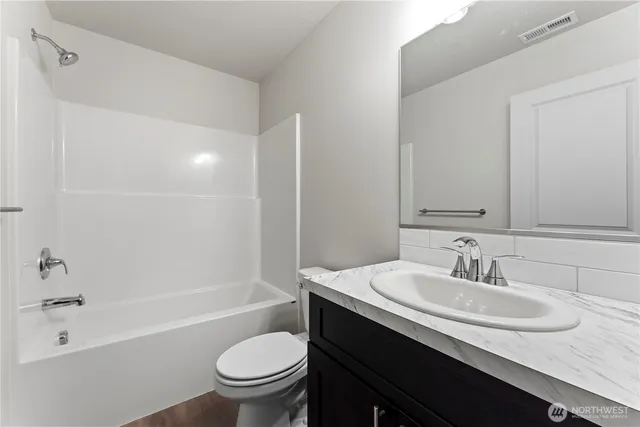 a bathroom with a sink a toilet and a bathtub