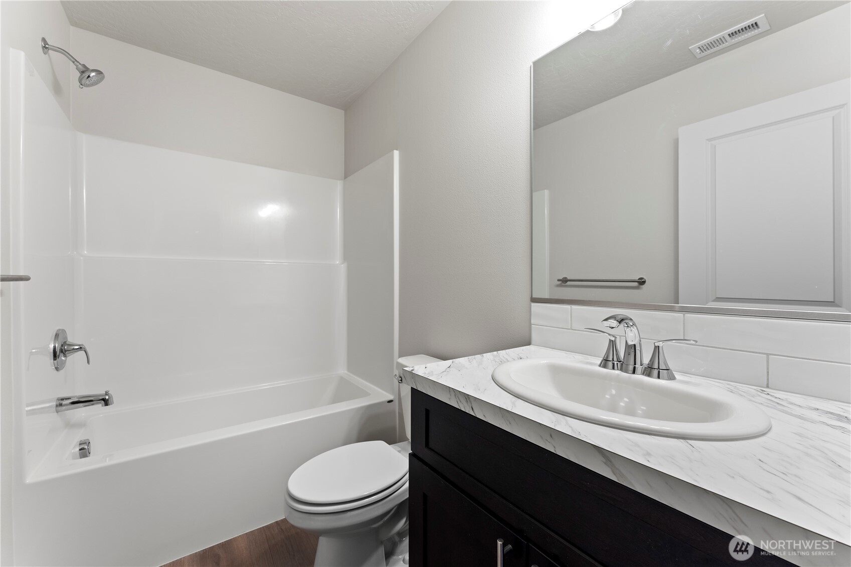 202 North Sandy Loop Moses Lake, WA 98837 - Photo 14 of 24 a bathroom with a sink a toilet and a bathtub