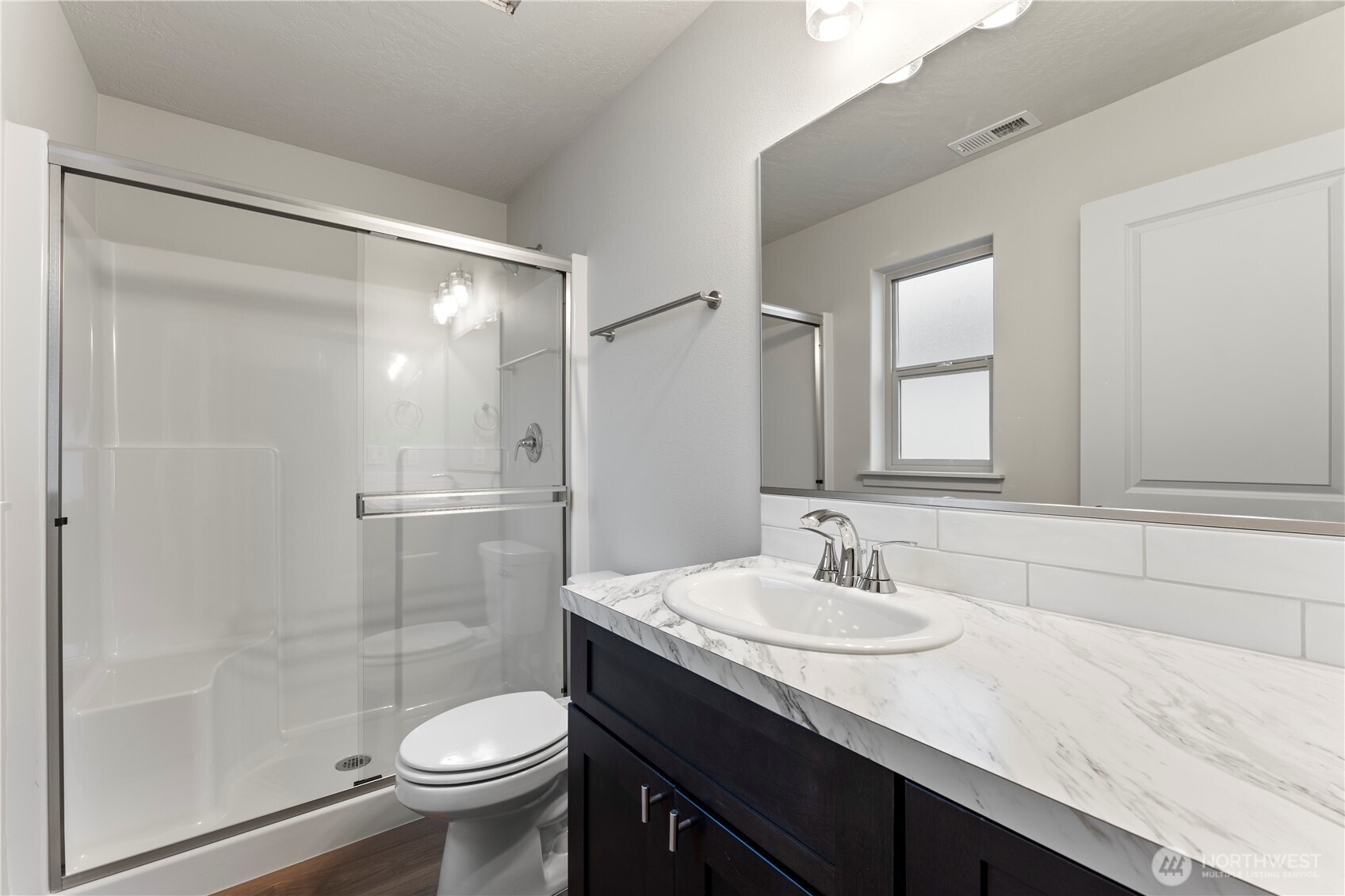 202 North Sandy Loop Moses Lake, WA 98837 - Photo 15 of 24 a bathroom with a sink a toilet and shower