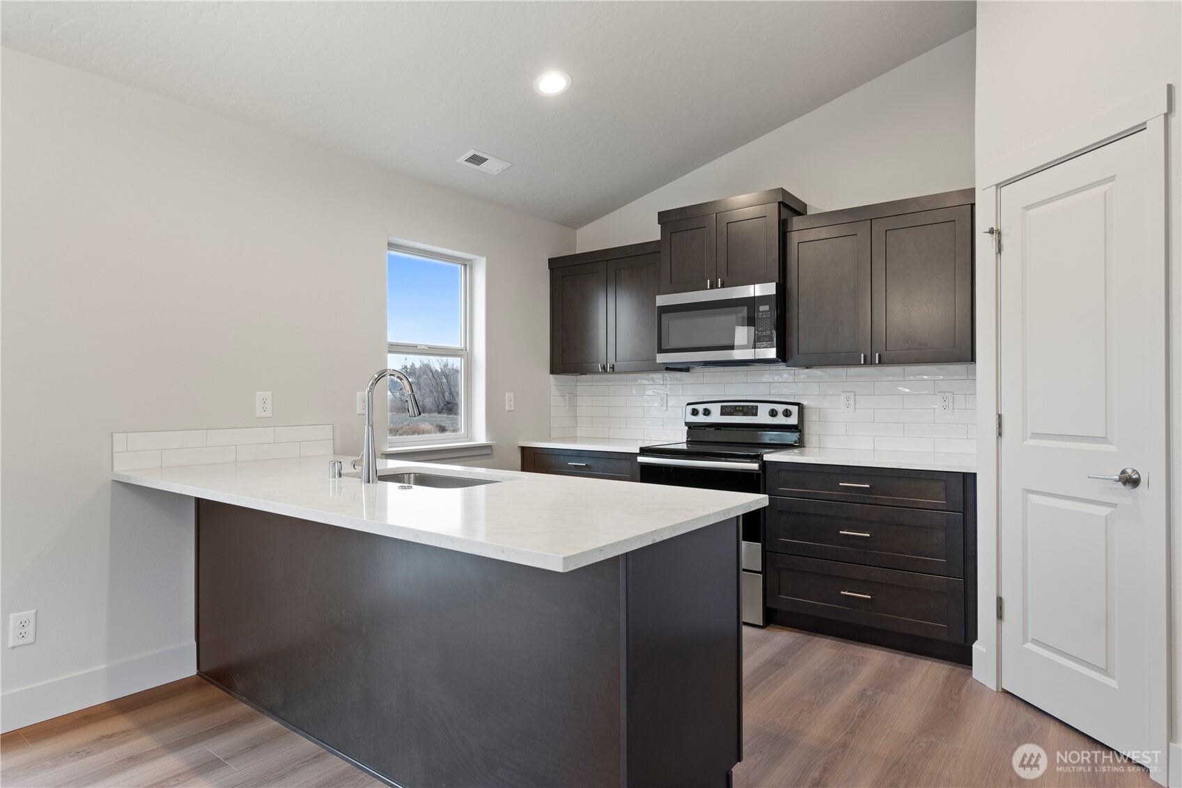 202 North Sandy Loop Moses Lake, WA 98837 - Photo 4 of 24 a kitchen with granite countertop stainless steel appliances and wooden cabinets
