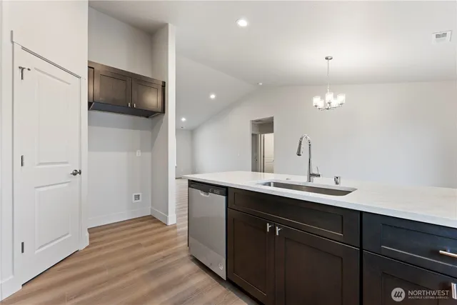 a kitchen with a sink and a mirror