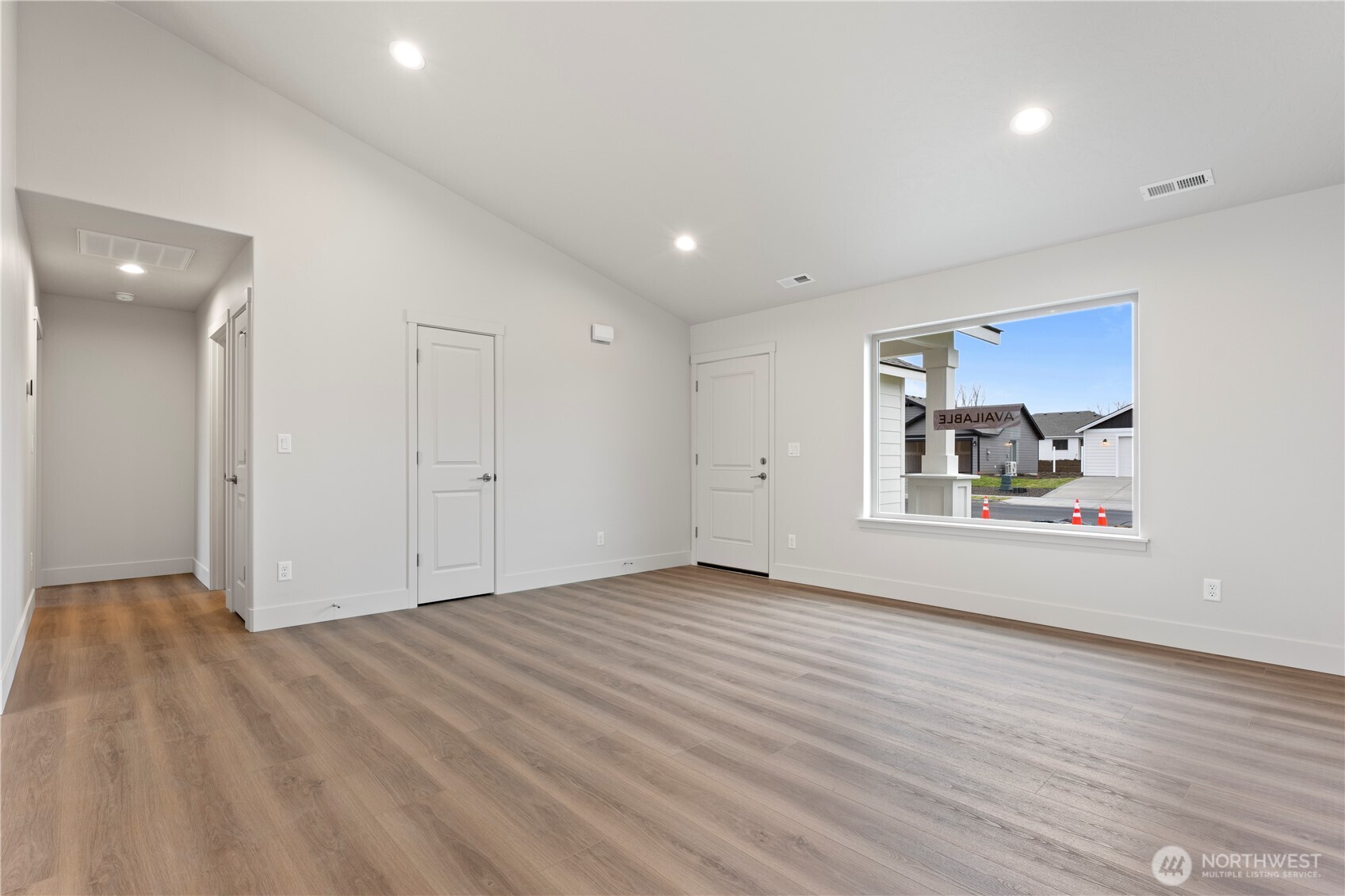 202 North Sandy Loop Moses Lake, WA 98837 - Photo 8 of 24 a view of an empty room with wooden floor and a window