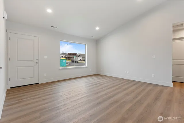 a view of an empty room and wooden floor