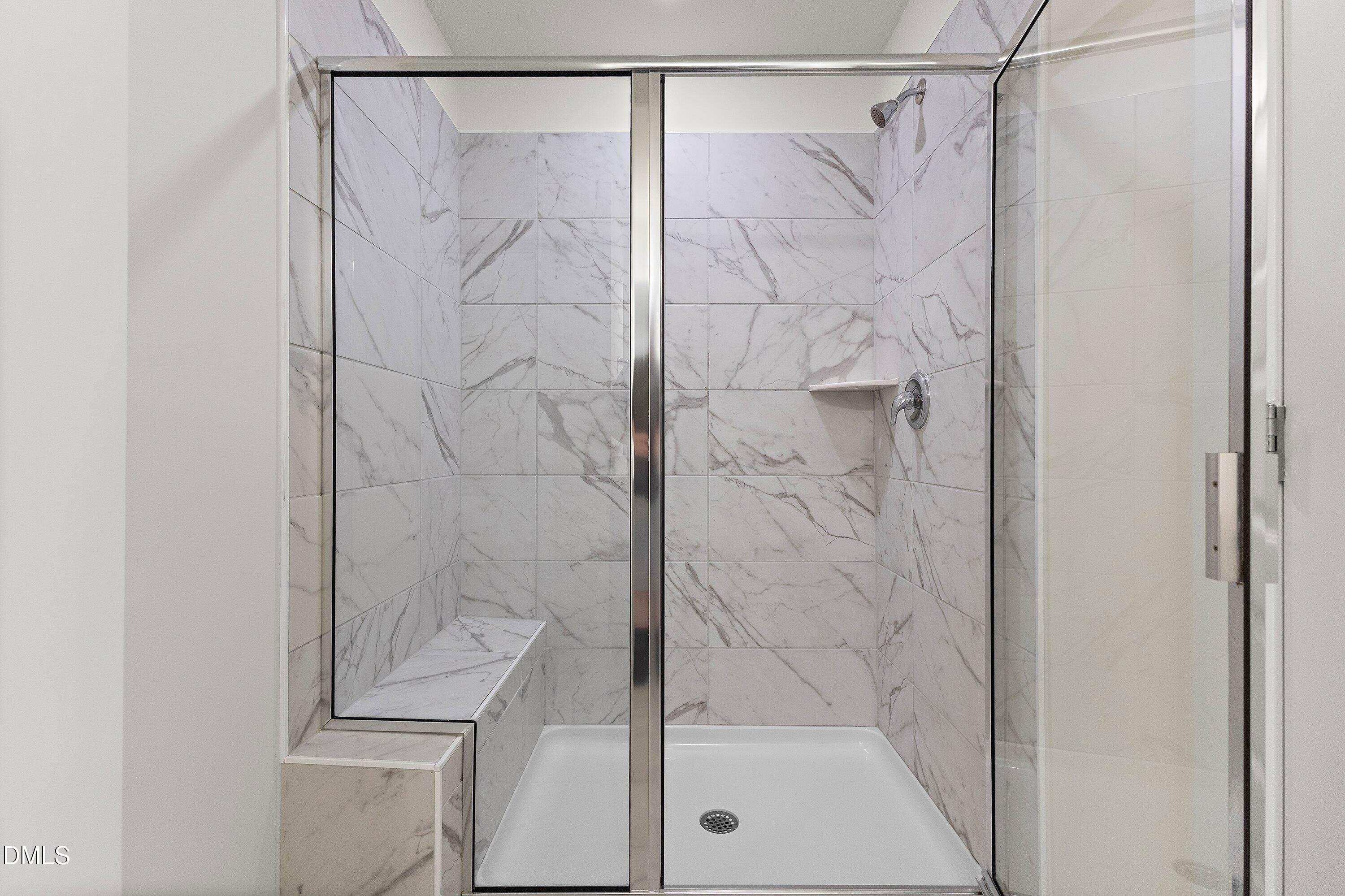 156 Sears Ridge Lane Morrisville, NC 27560 - Photo 23 of 49 a bathroom with a glass shower door