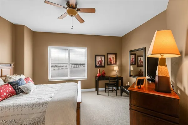 a bedroom with a large bed and a lamp