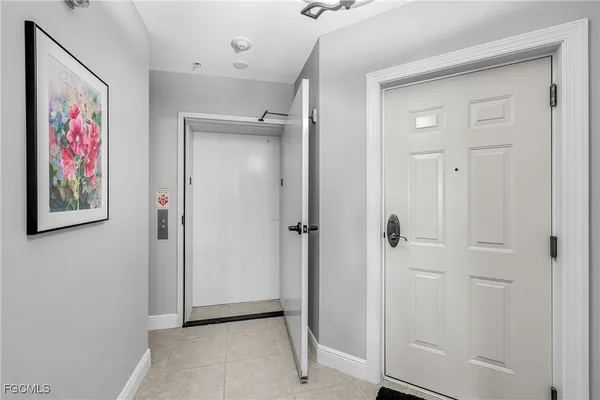 a large white kitchen with a large window