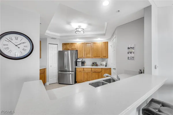 a kitchen with granite countertop a refrigerator stove and sink