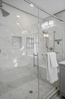 a bathroom with a tub a sink and mirror