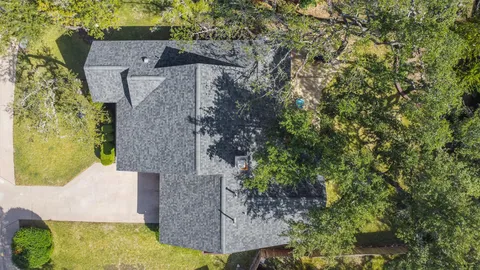 an aerial view of a house with a yard basket ball court and outdoor seating
