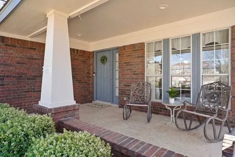 a building outdoor space with patio furniture and potted plants