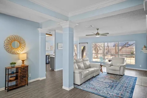 a living room with furniture and a wooden floor