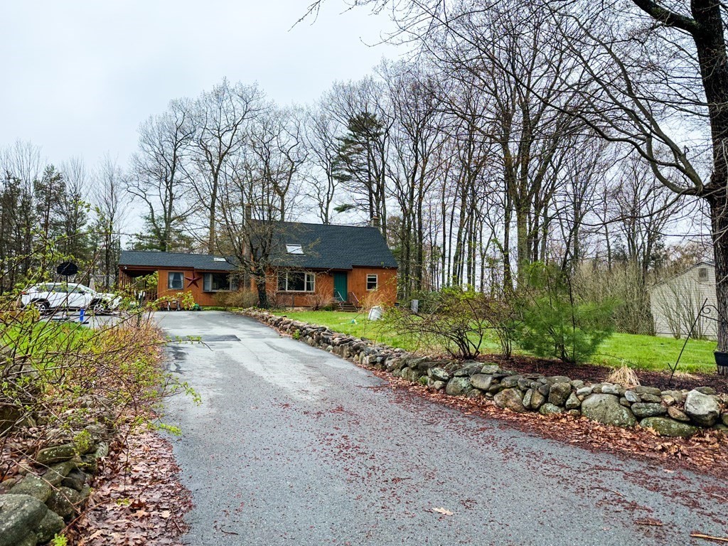 119 Dunn Road Ashburnham, MA 01430 - Photo 3 of 26 a front view of a house with a garden and tree