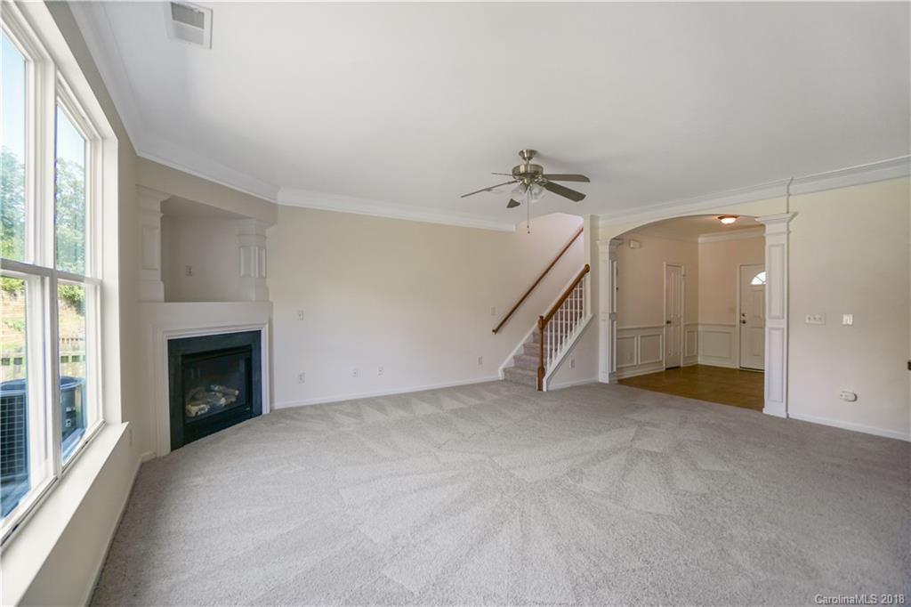 12918 Rothe House Road Charlotte, NC 28273 - Photo 13 of 25 an empty room with fireplace and windows