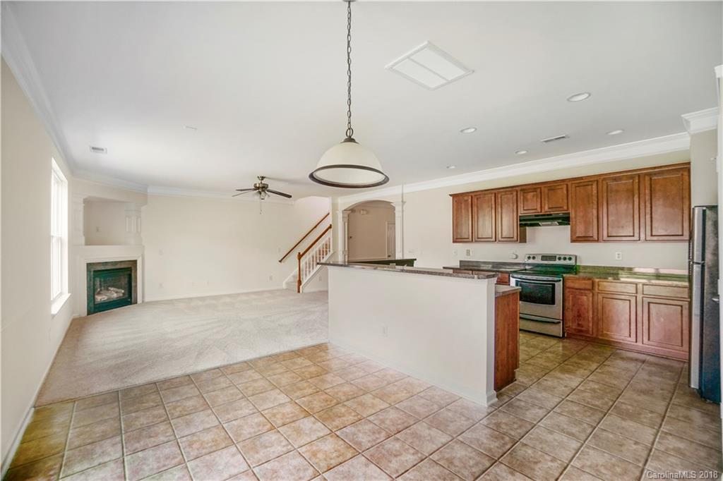 12918 Rothe House Road Charlotte, NC 28273 - Photo 14 of 25 a kitchen with stainless steel appliances granite countertop a stove a sink and a refrigerator