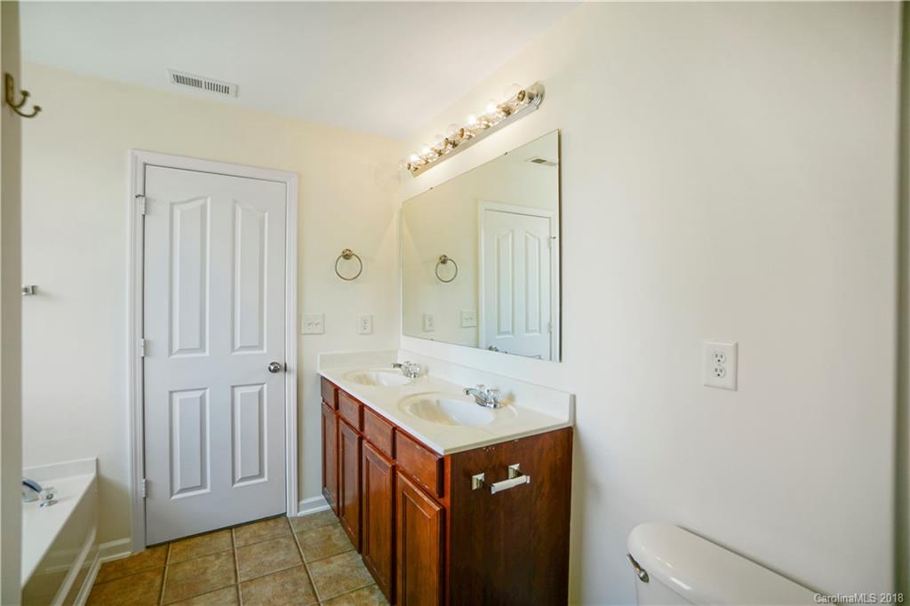 12918 Rothe House Road Charlotte, NC 28273 - Photo 23 of 25 a bathroom with a sink and a mirror