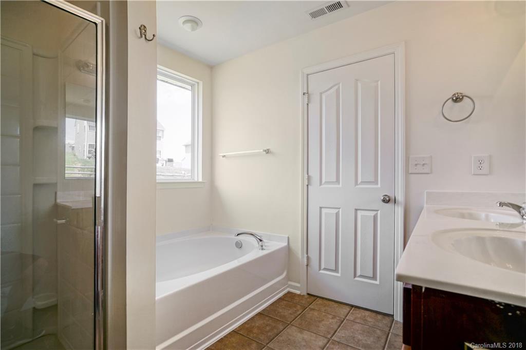 12918 Rothe House Road Charlotte, NC 28273 - Photo 24 of 25 a bathroom with a bathtub and a sink