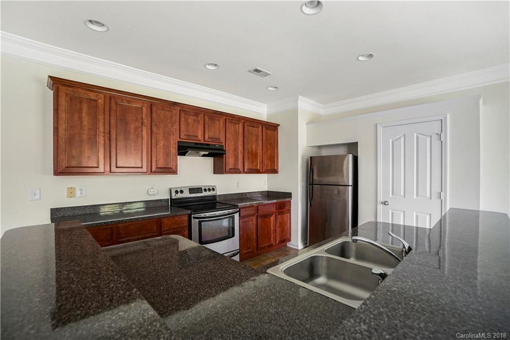 12918 Rothe House Road Charlotte, NC 28273 - Photo 4 of 25 a kitchen with stainless steel appliances granite countertop a refrigerator stove sink and dishwasher