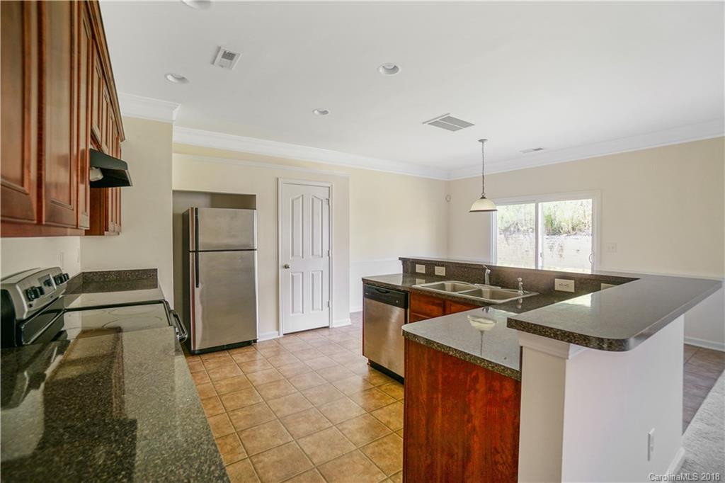 12918 Rothe House Road Charlotte, NC 28273 - Photo 6 of 25 a kitchen with stainless steel appliances granite countertop a sink stove and refrigerator