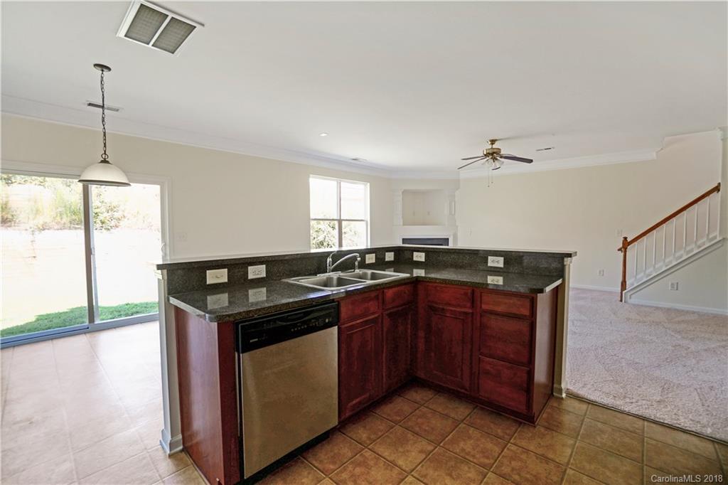 12918 Rothe House Road Charlotte, NC 28273 - Photo 8 of 25 a kitchen with a stove and a sink